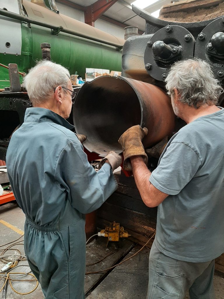 John Dixon and Keith Brewer removing the liner