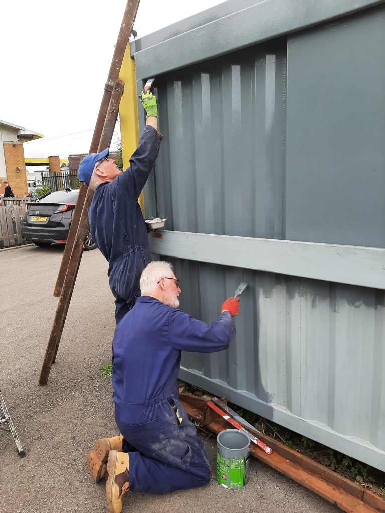 Jon and Sim applying undercoat grey to the north side of the mess room.