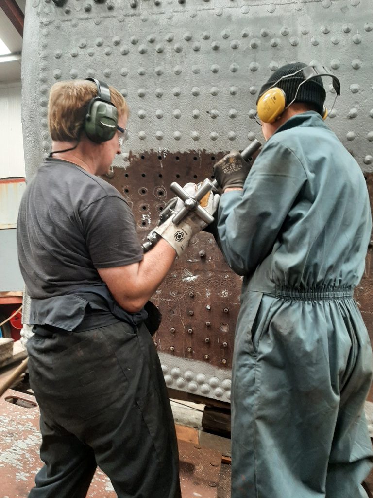 Chris Rycroft and John Dixon reaming out stay holes on 5643's firebox