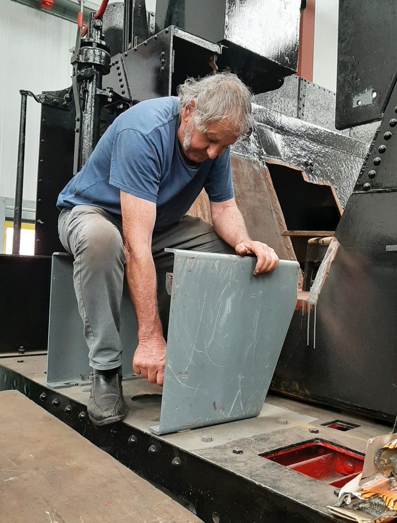 Keith Brewer fixes a footplate support bracket to Wootton Hall's tender