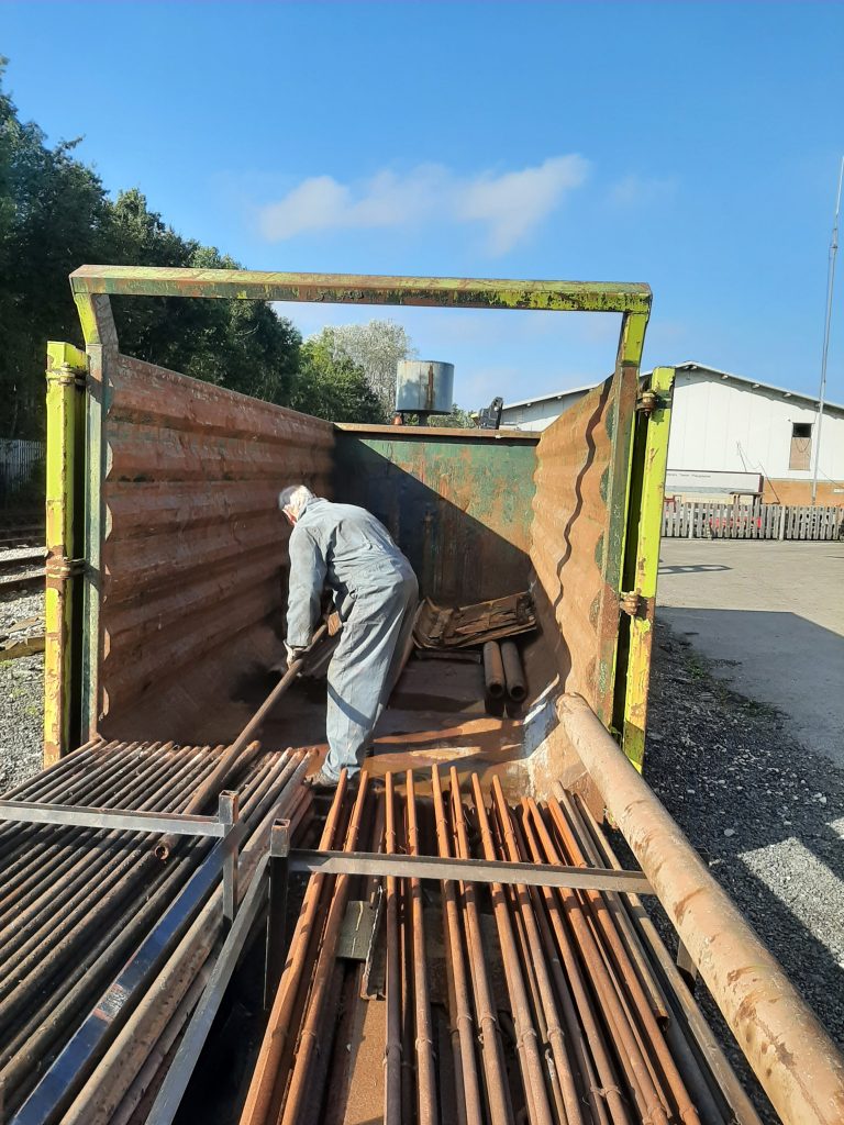 John Dixon starts the job of loading the second hand boiler tubes into the skip