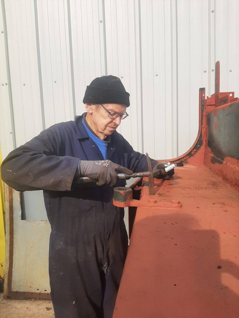 John Dixon removing rust from 5643's bunker