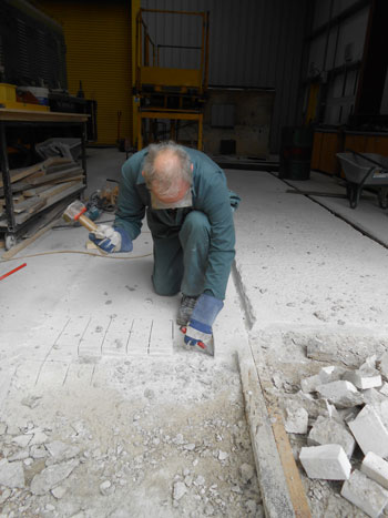 ... while John sets to, to provide an edge for the new apron concrete to key onto
