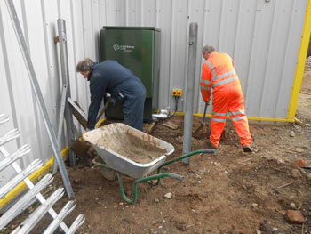 Concreting in the base of the new fence around the heating equipment