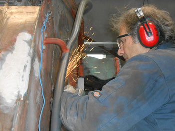 Meanwhile Mike follows on, grinding off excess weld on the ends